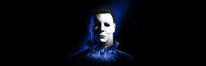 Halloween The Game key art featuring Michael Myers over a Haddonfield street