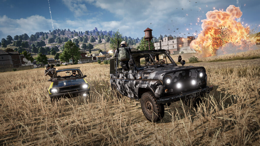 PUBG: Battlegrounds gameplay — a squad in a UAZ chasing another car across Erangel as an explosion erupts