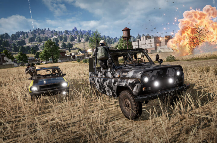 PUBG: Battlegrounds gameplay — a squad in a UAZ chasing another car across Erangel as an explosion erupts