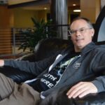 Epic Games CEO Tim Sweeney seated, wearing an Epic Games hoodie