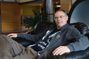 Epic Games CEO Tim Sweeney seated, wearing an Epic Games hoodie